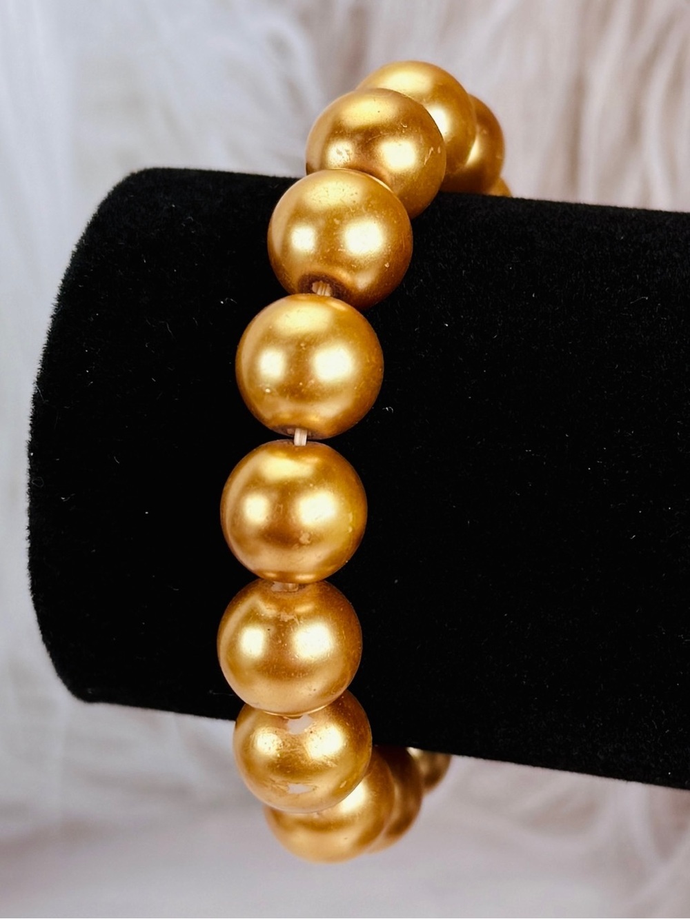 Goldtone, weighted costume stretch bracelet